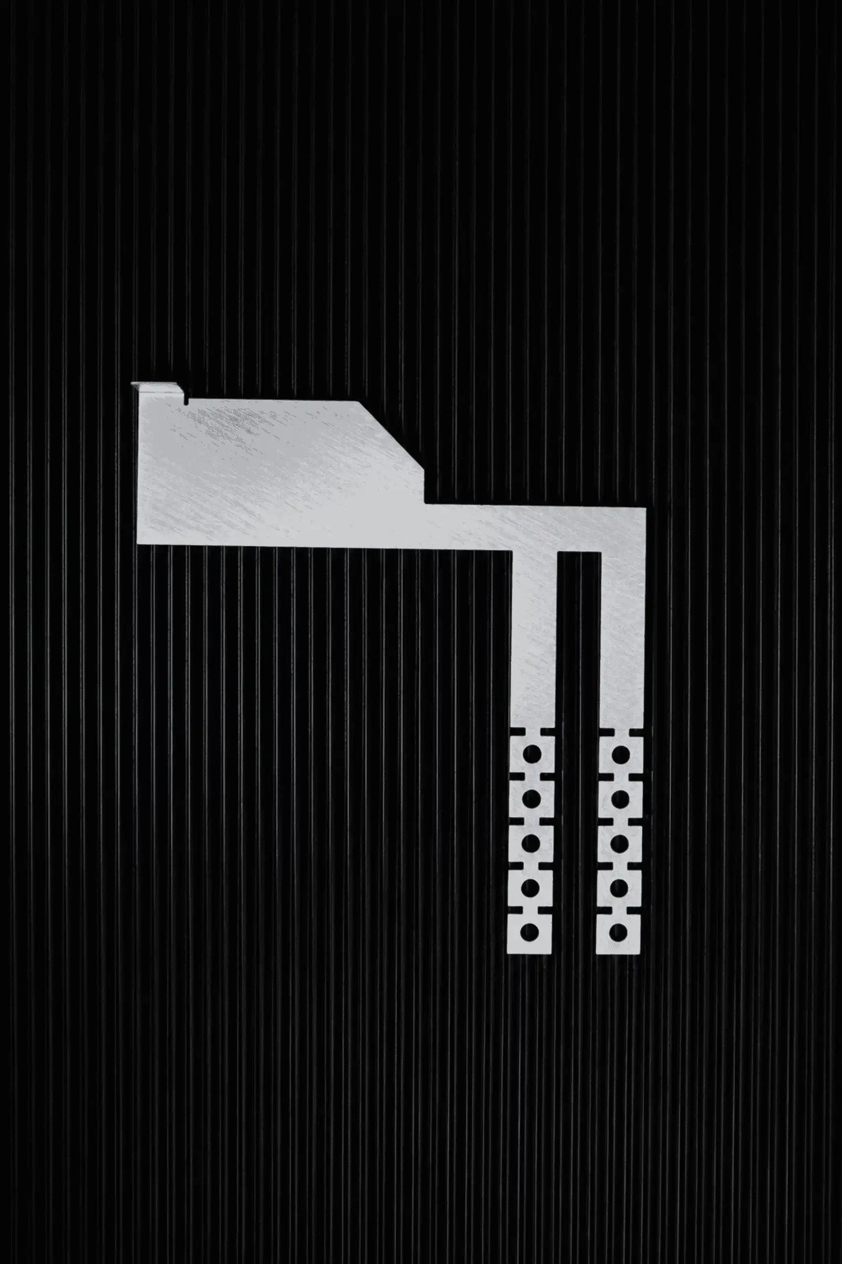 Photo of the Interlockkit adjustable single column breaker retainer on a black background