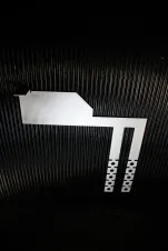Photo of the Interlockkit adjustable single column breaker retainer on a black background