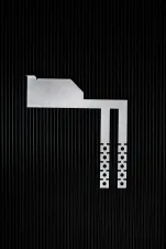 Photo of the Interlockkit adjustable single column breaker retainer on a black background